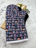 Oven Mitts. Books. Bookshelf Cat.