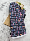 Oven Mitts. Books. Bookshelf Cat.