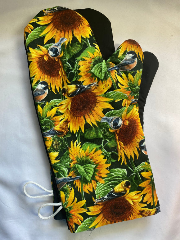 Oven mitts. Flowers. Sunflowers and blue birds