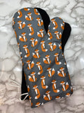 Oven mitts. Animals. Foxes on grey